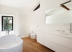 A bathroom with white paint wall and wooden floor