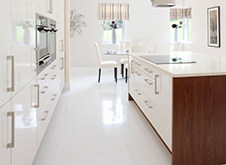 Renovated white motif island kitchen with high gloss cabinets.