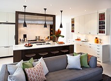 An open-plan kitchen with grey sofa