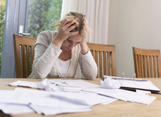 A lady looking tense reviewing home plans