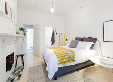 A bedroom that has an en-suite bathroom and view to the landing
