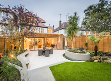 A landscaped garden with large living area that opens out on to it