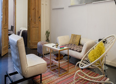 A living room with sofa and central table