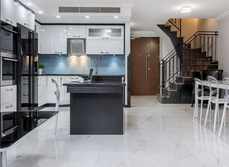 A open plan kitchen, living room and and dining area with open stairway.