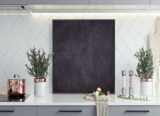 A kitchen worktop with hob and rose gold kitchen accessories on display.