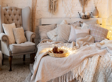 A bedroom showcasing lots of soft furnishing ideas