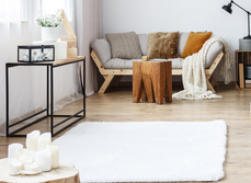 A cosy living room with rug, candles, rug and a homely feel.