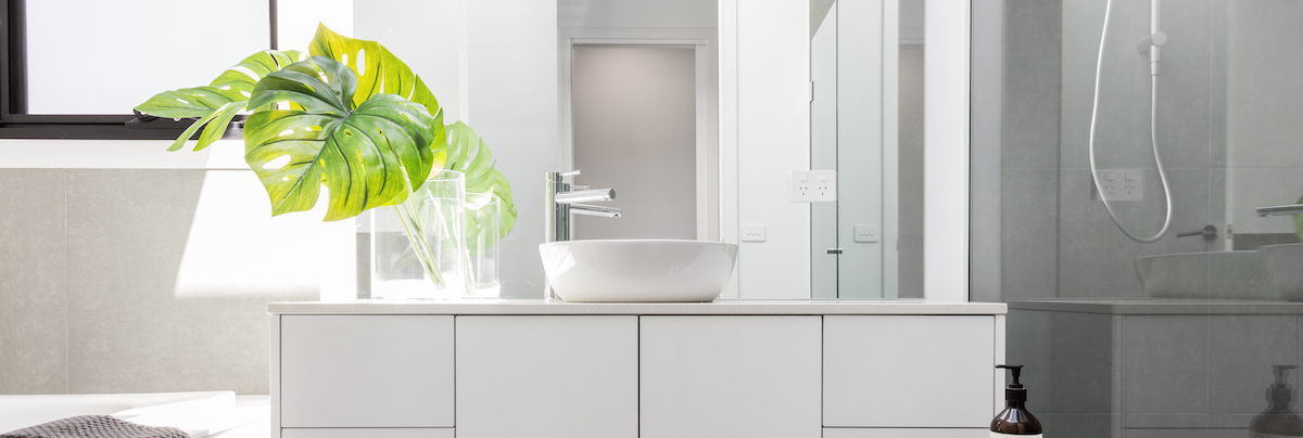 Beautiful white bathroom accompanied with a large Montserra