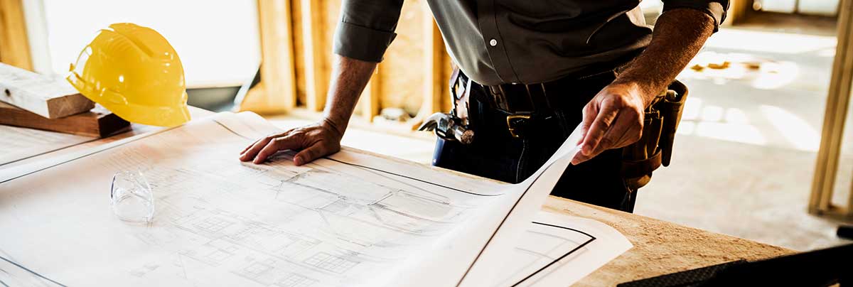 architect looking through building plan drawings
