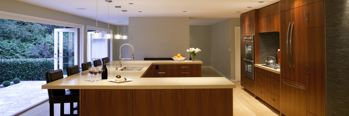 A large bungalow kitchen with open doors.