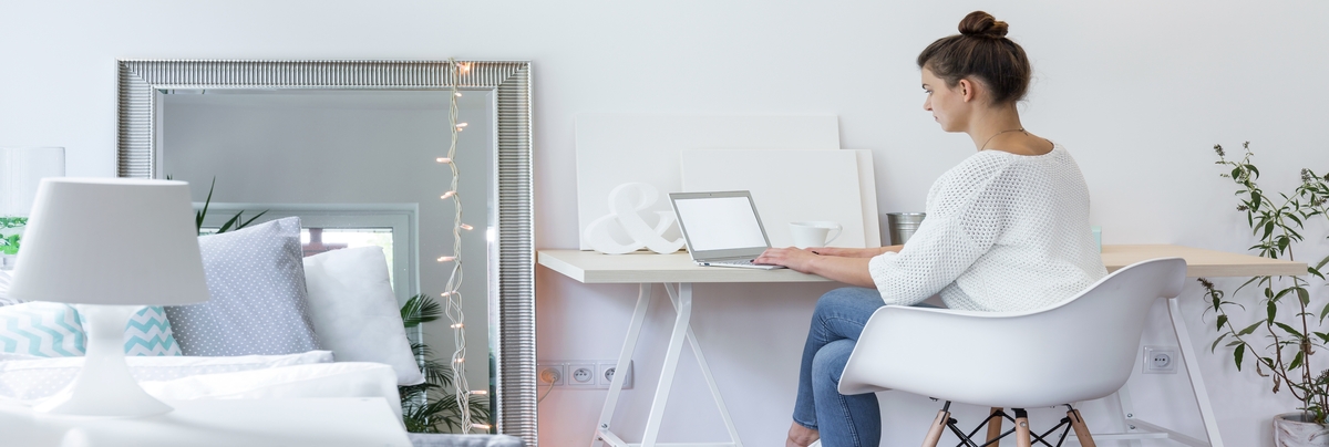 A lady working at a desk in her newly converted office space
