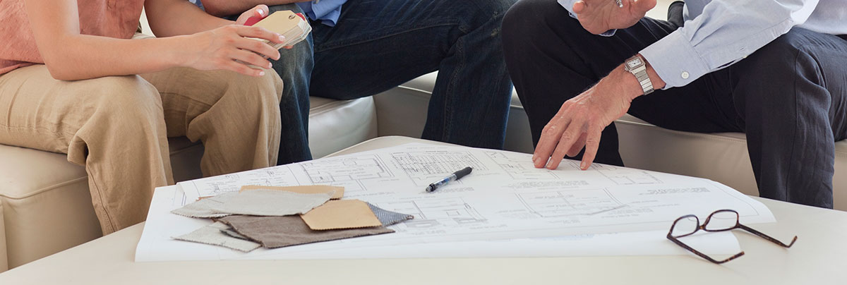 home owners looking over plans with architect in Cambridge