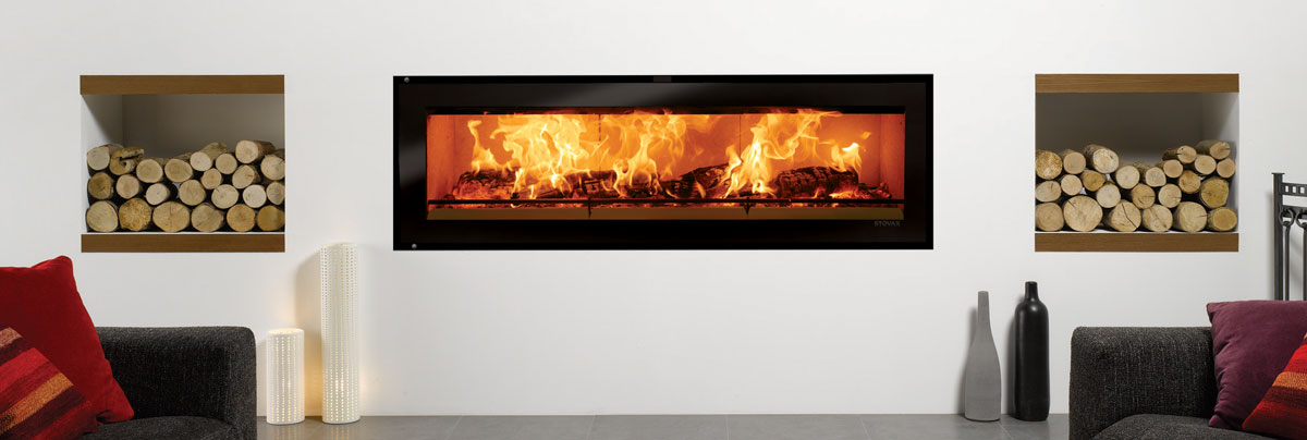 Modern, fixed wood fire burner installed into wall.