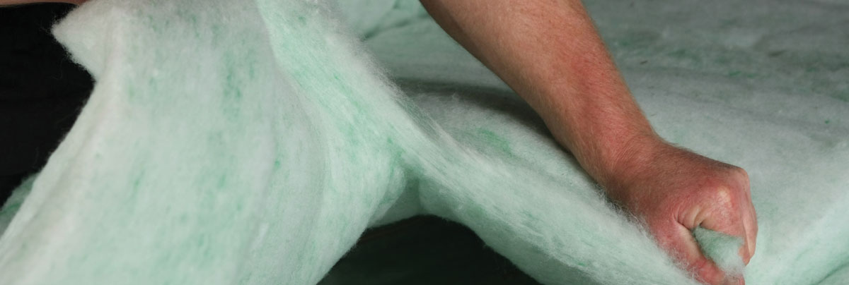 Person preparing insulation material.