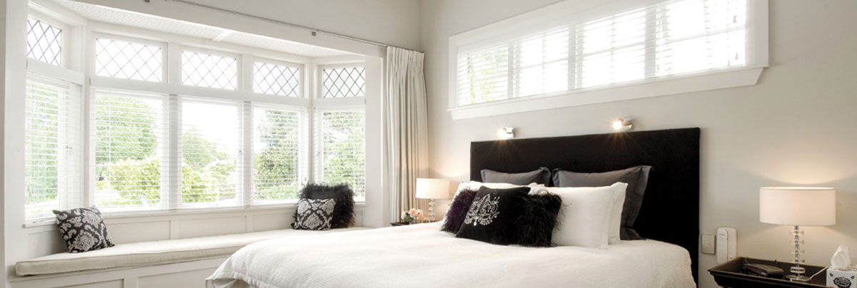Dan O'Connor bay or box window above window seat in white-palette double bedroom