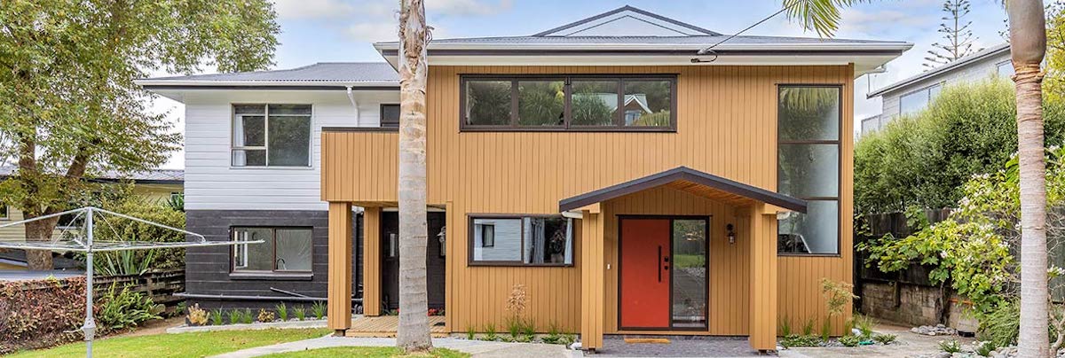 Rejuvenating a home's entrance with warm timber Recladding, soft landscaping, and a pop of colour.