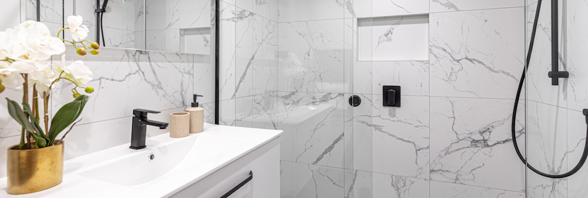 An apartment renovation in Grey Lynn, Auckland, with marble tiles and a bi-fold wardrobe.