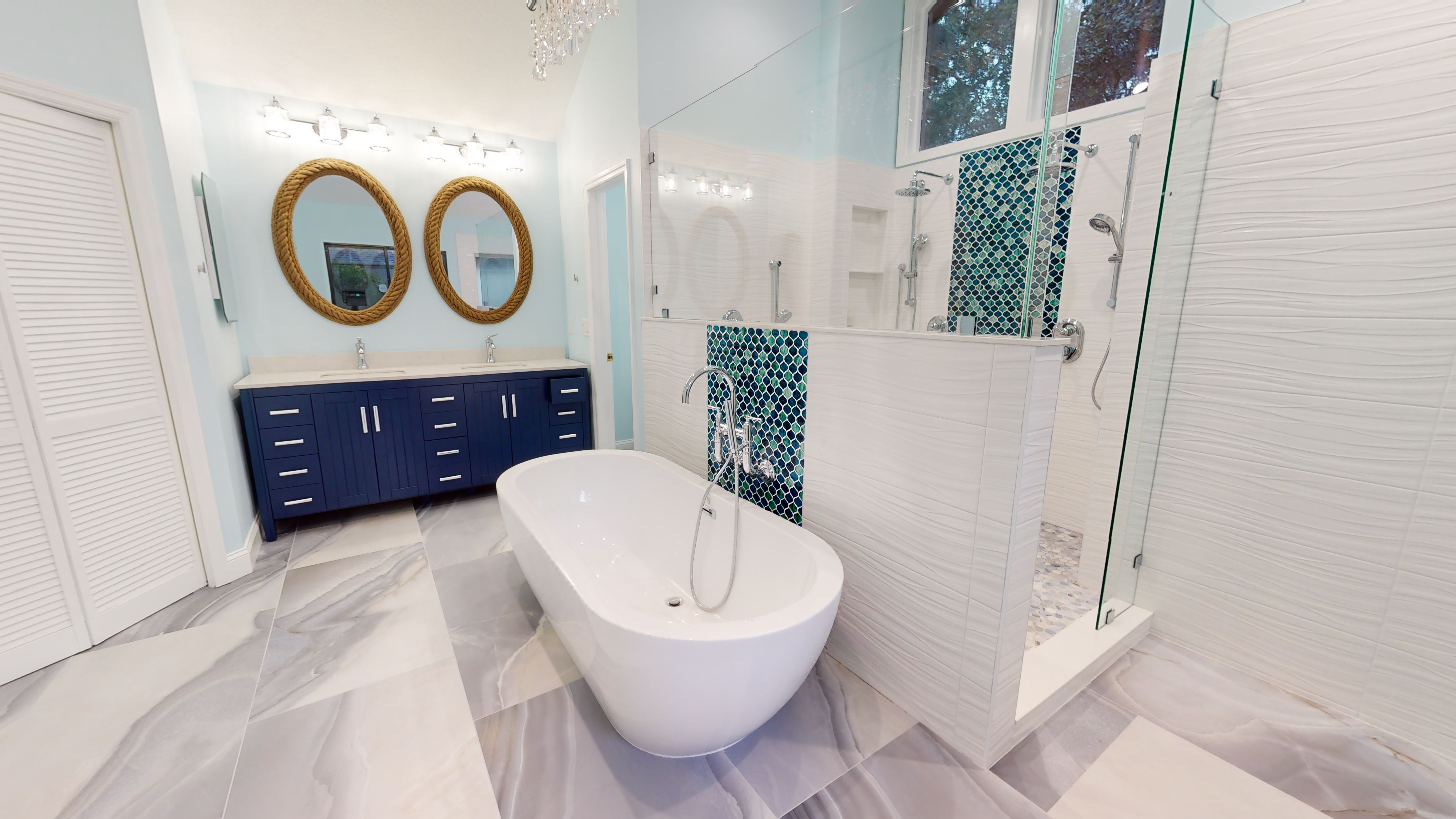 This renovation transformed an outdated, water damaged master bathroom into a new, modern, ocean blue and luxurious master bathroom. 