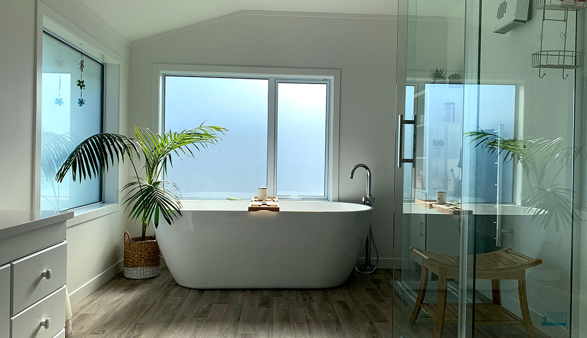 A beautifully finished bathroom with wooden flooring and natural light colours from a bathroom renovation refresh completed in Invercargill.