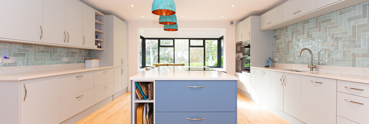 Open kitchen space with blue stand-alone kitchen island