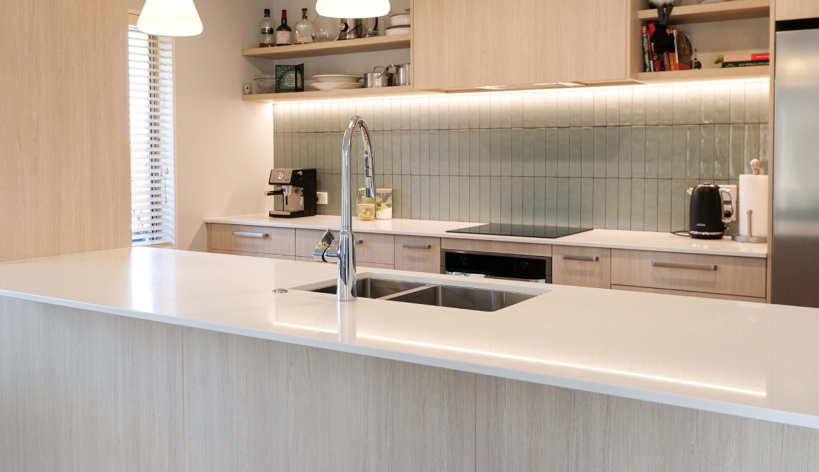 Kitchen renovation with bright lighting and modern glass cooktop