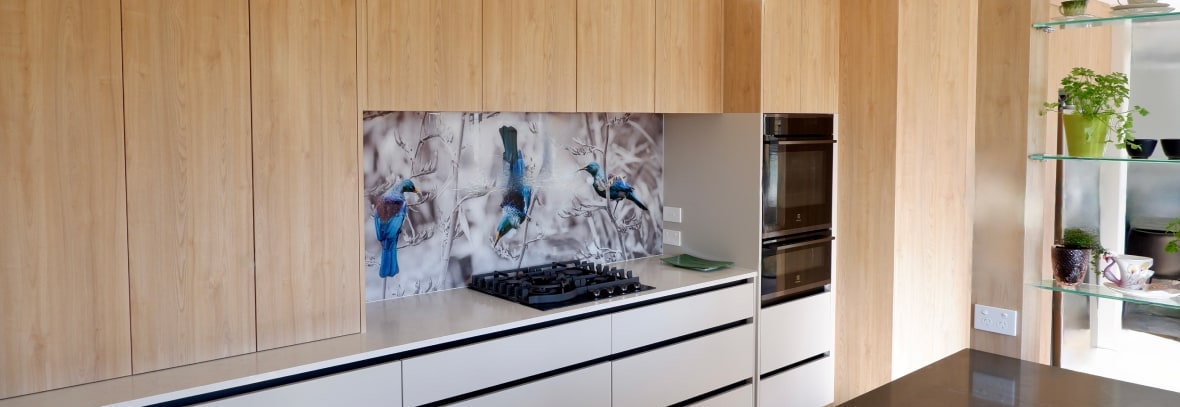 kitchen with wooden cabinets and print splashback