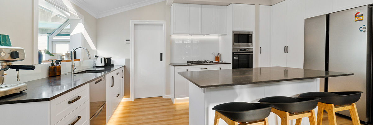 kitchen with white cabinets and wooden floor