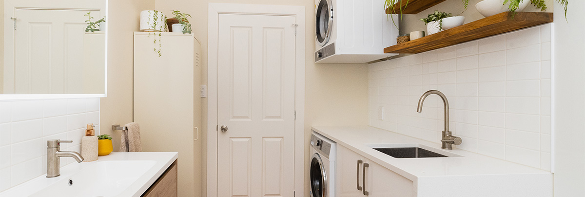 Laundry and bathroom with white bench tops
