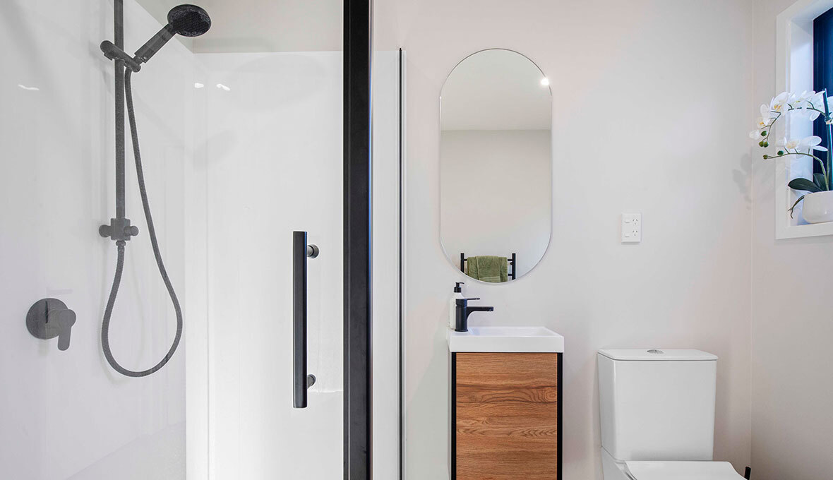 Small bathroom renovation in New Zealand with black hardware