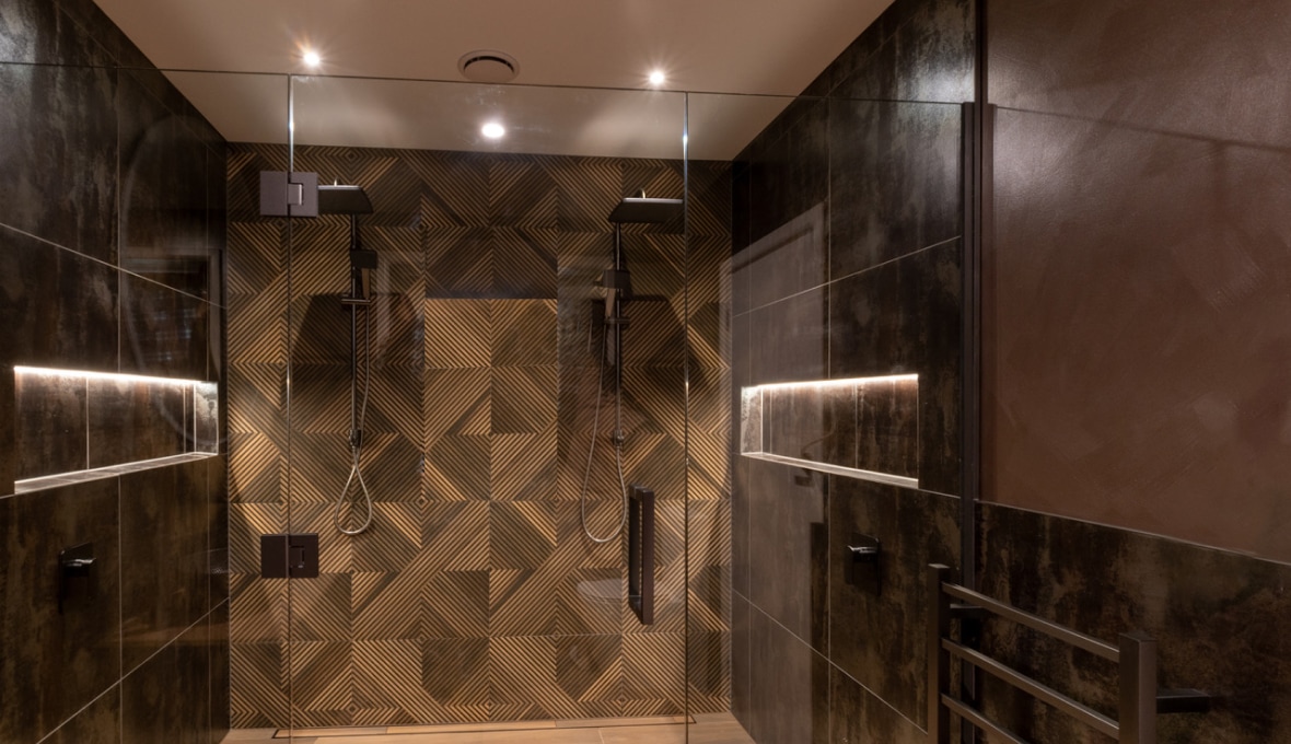 Double shower with playful wallpapers and moody metallic paint 