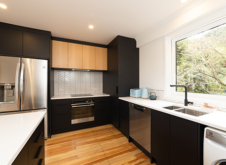 Modern kitchen with black and timber accents