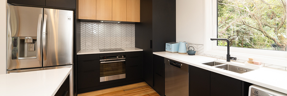 Modern kitchen with black and timber accents