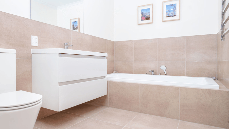 Half tiled bathroom with built-in Bath and wall-hung vanity