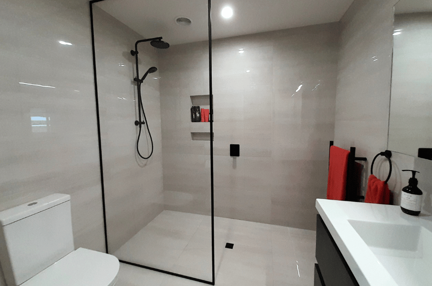 modern bathroom with grey tiles and black fixtures