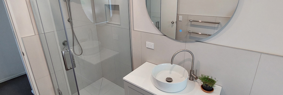 Circular mirror and white vanity