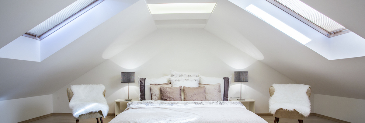 Attic with skylight windows converted into a bedroom