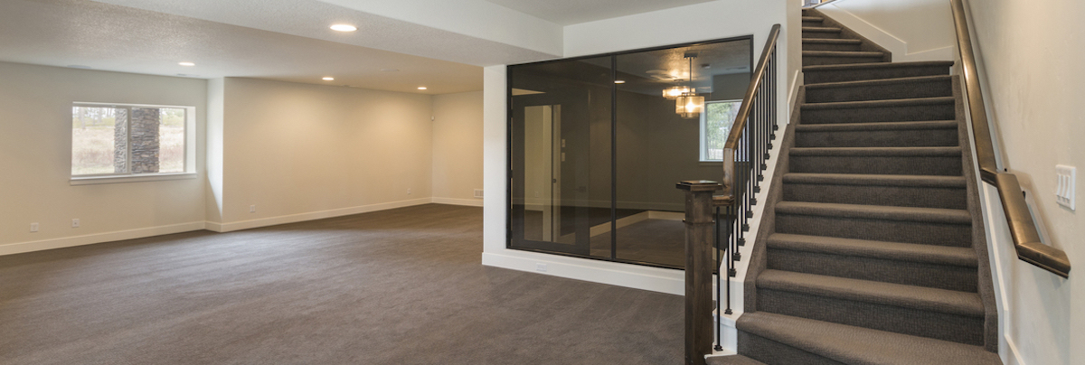 Carpeted basement with stairs 