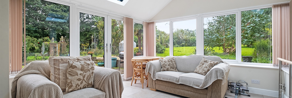 blankets on couch in a conservatory