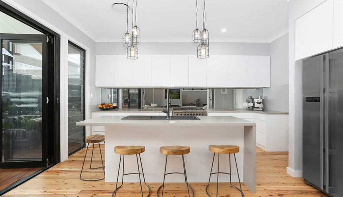 Modern kitchen renovation in Nelson with a white countertop kitchen island