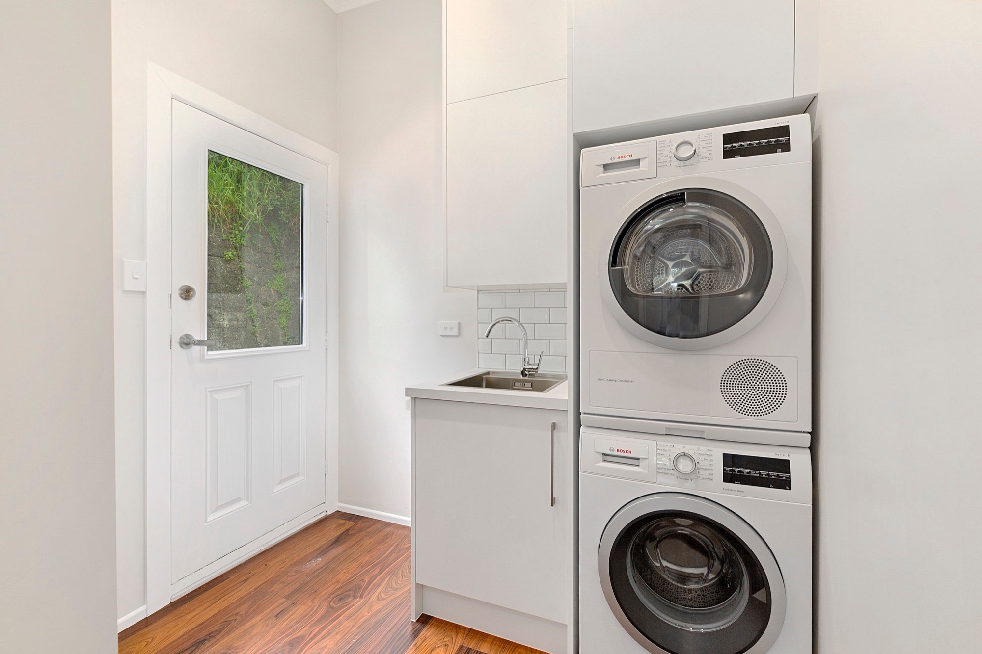 Laundry room with sleek white palette