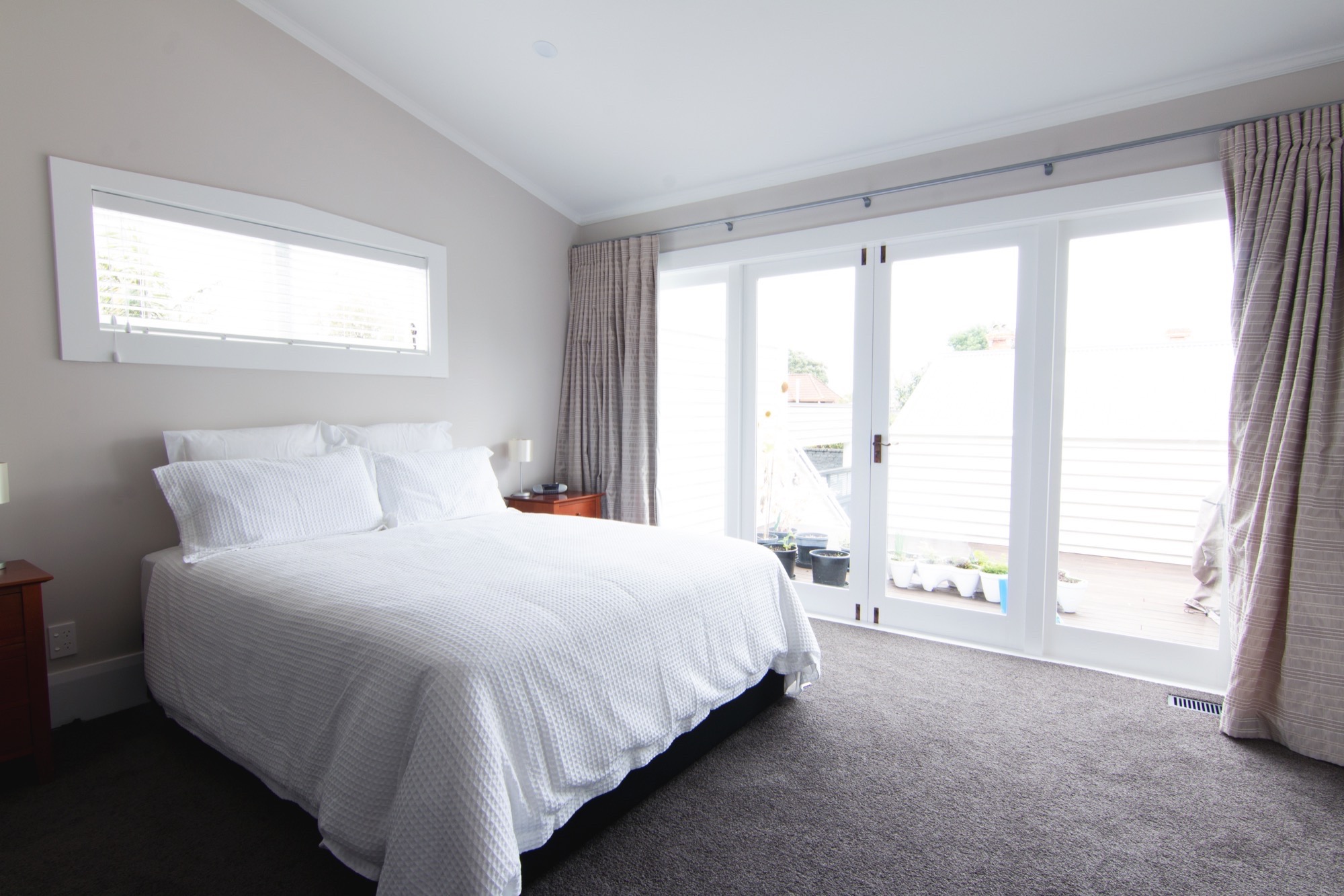 Bedroom with folding doors leading to the balcony