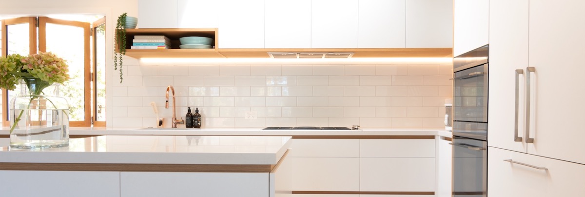 Clean kitchen with underlit splashback