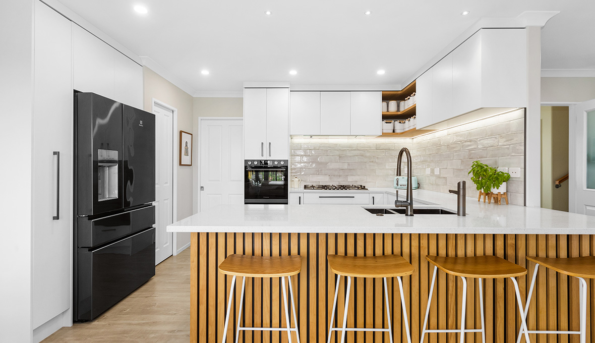 Hamilton kitchen renovation with white cabinets and countertop and vertical wood panelling