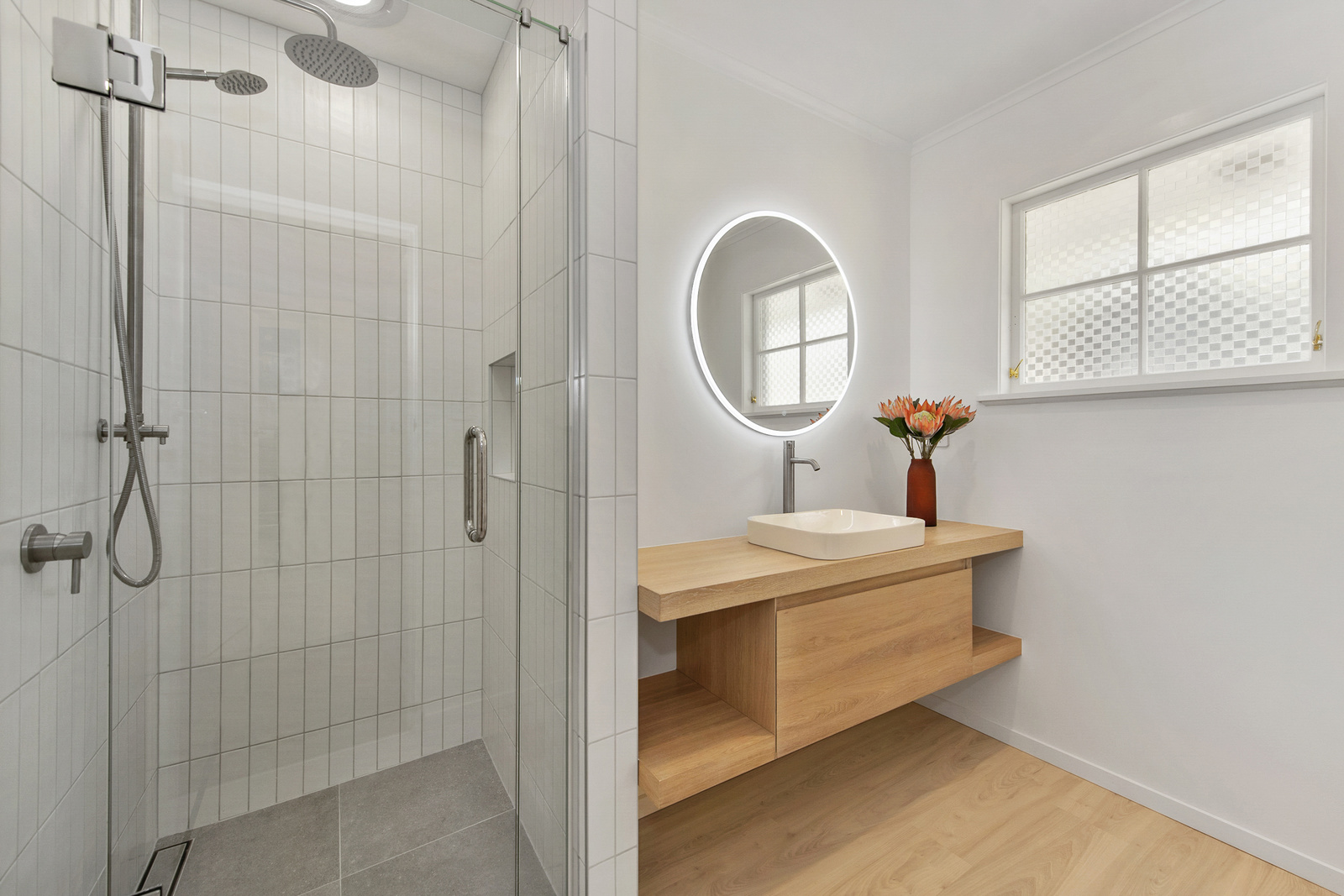Modern bathroom renovation with a shower and sink, complemented by an LED mirror – Inspiring ideas for bathroom renovations in waikato.