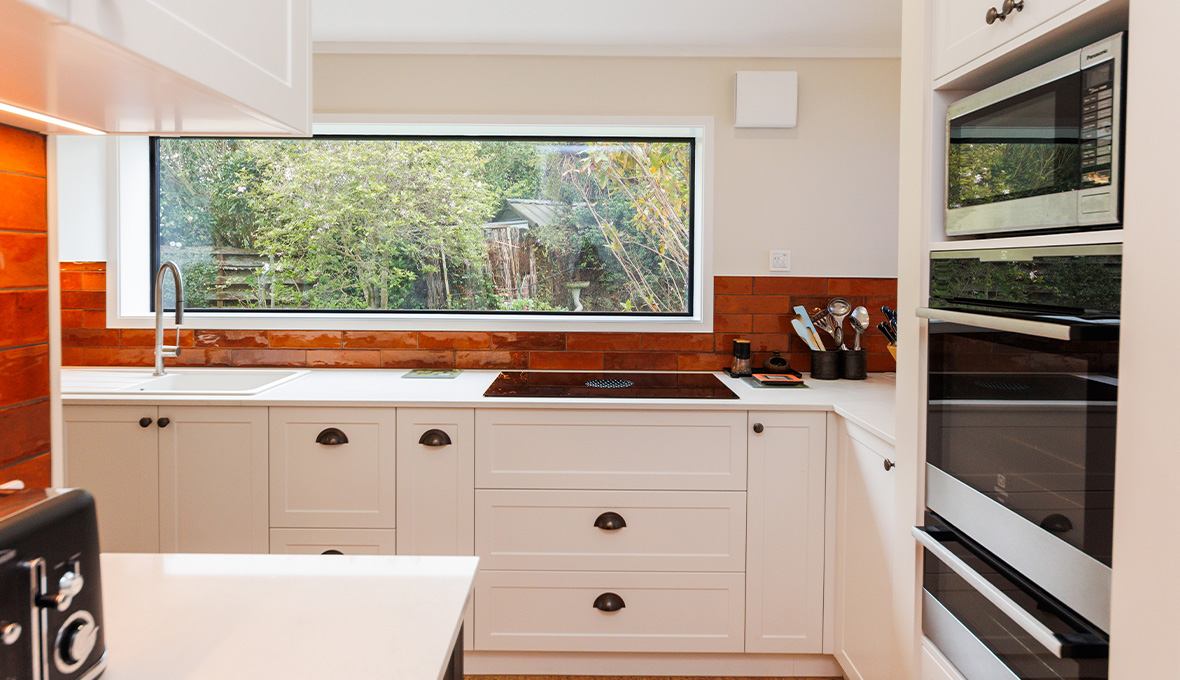 Modern kitchen renovation with glass cooktop and sleek sink
