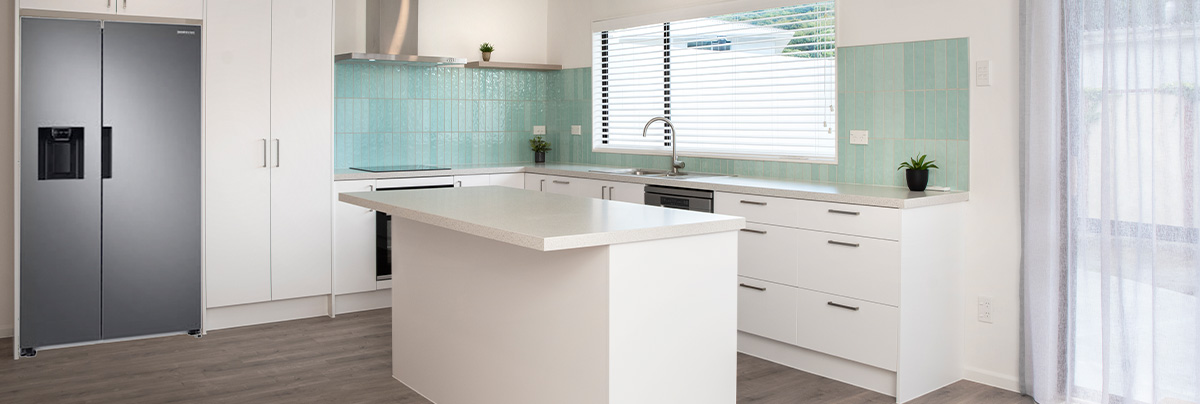 Modern small kitchen with turquoise tiles and white kitchen island