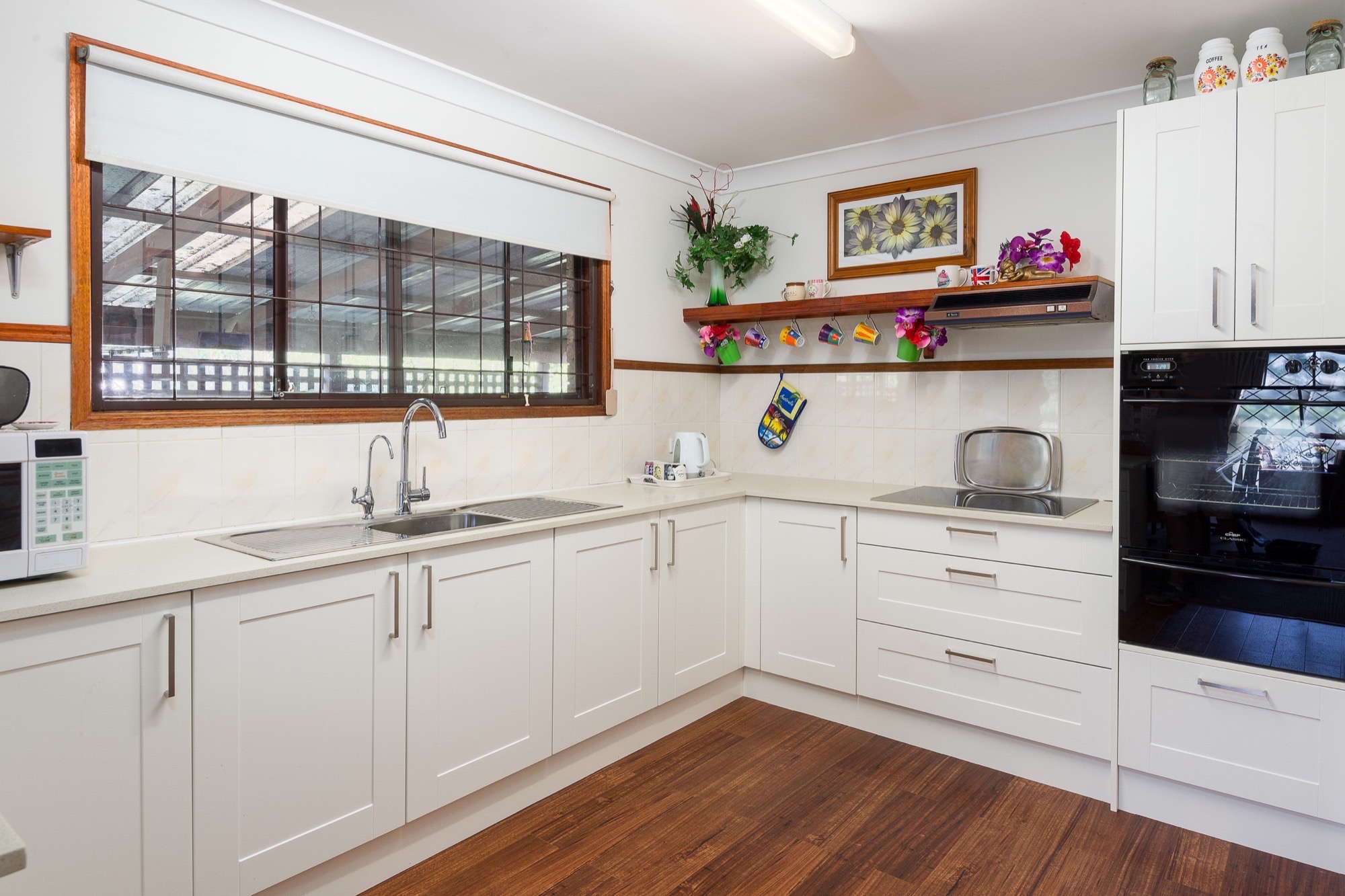 A white kitchen with timber accents