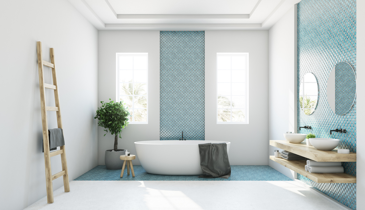 bathtub in middle of bathroom and blue small tiles