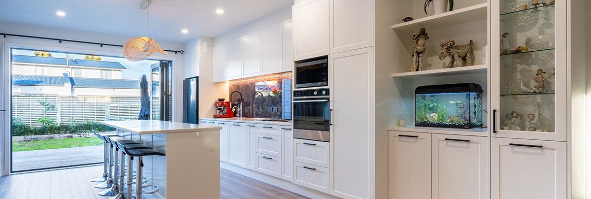 Spacious modern wooden kitchen in West Auckland with a black top kitchen island