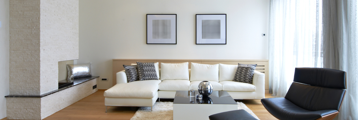 white couch next to brick fireplace in modern lounge